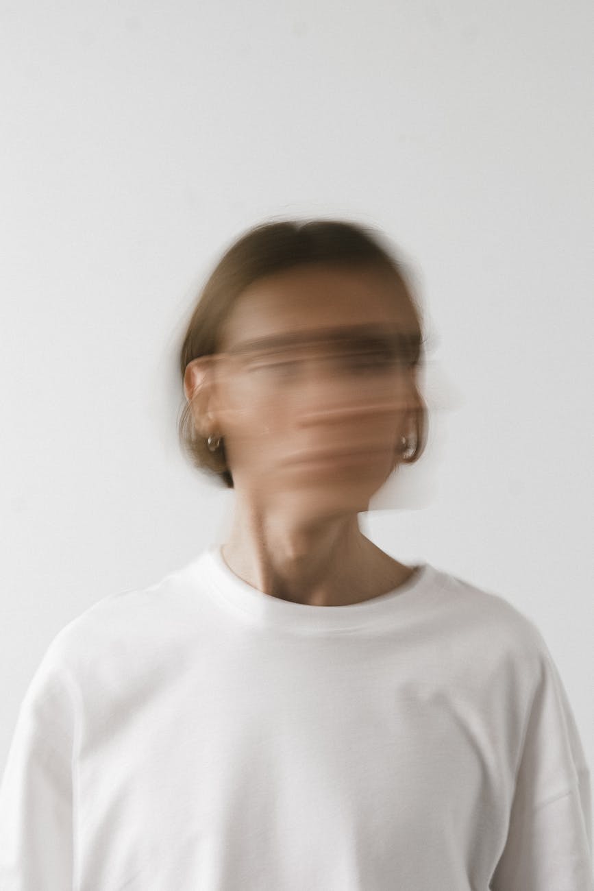 a person in white shirt with a blurred face